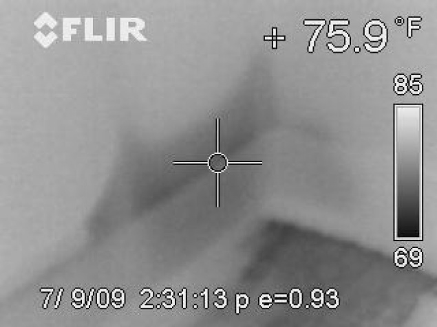Thermal images of wet wall behind baseboard